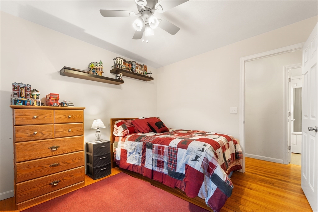 42 South Hunt Road Amesbury, MA 01913 - Photo 15 of 26 a bedroom with a bed and a chandelier