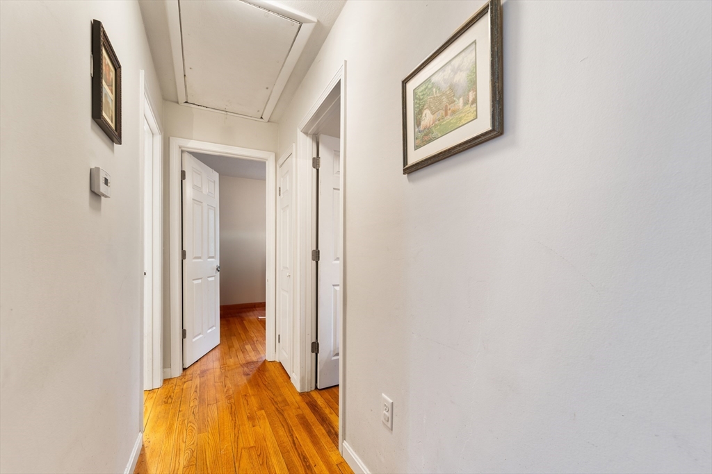 42 South Hunt Road Amesbury, MA 01913 - Photo 17 of 26 a bedroom with a bed and a wall painting