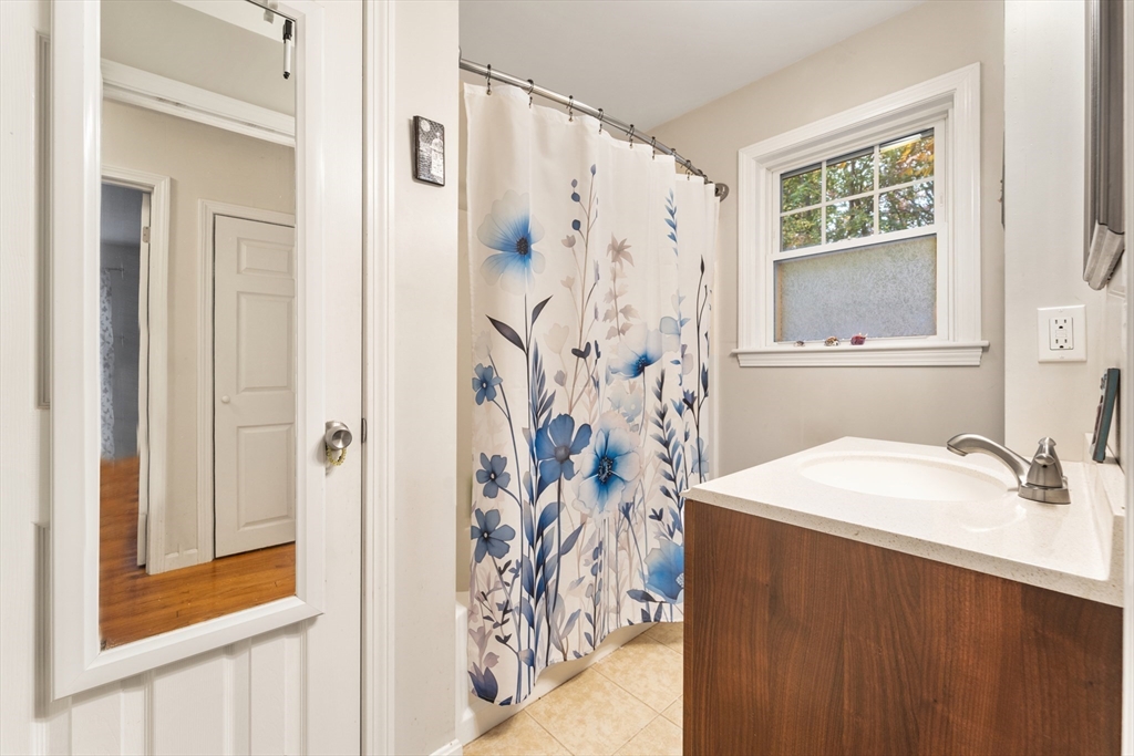 42 South Hunt Road Amesbury, MA 01913 - Photo 18 of 26 a bathroom with a sink a mirror and a shower