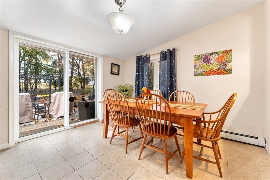 42 South Hunt Road Amesbury, MA 01913 - Photo 7 of 26 a view of a dining room with furniture wooden floor and chandelier