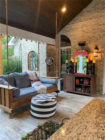 a view of a patio with table and chairs potted plants with wooden floor