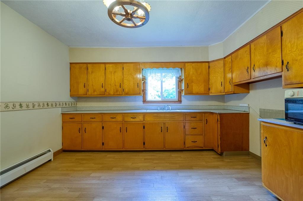 246 Mccloy Road Beaver Falls, PA 15010 - Photo 8 of 22 a view of a kitchen with wooden floor and a sink