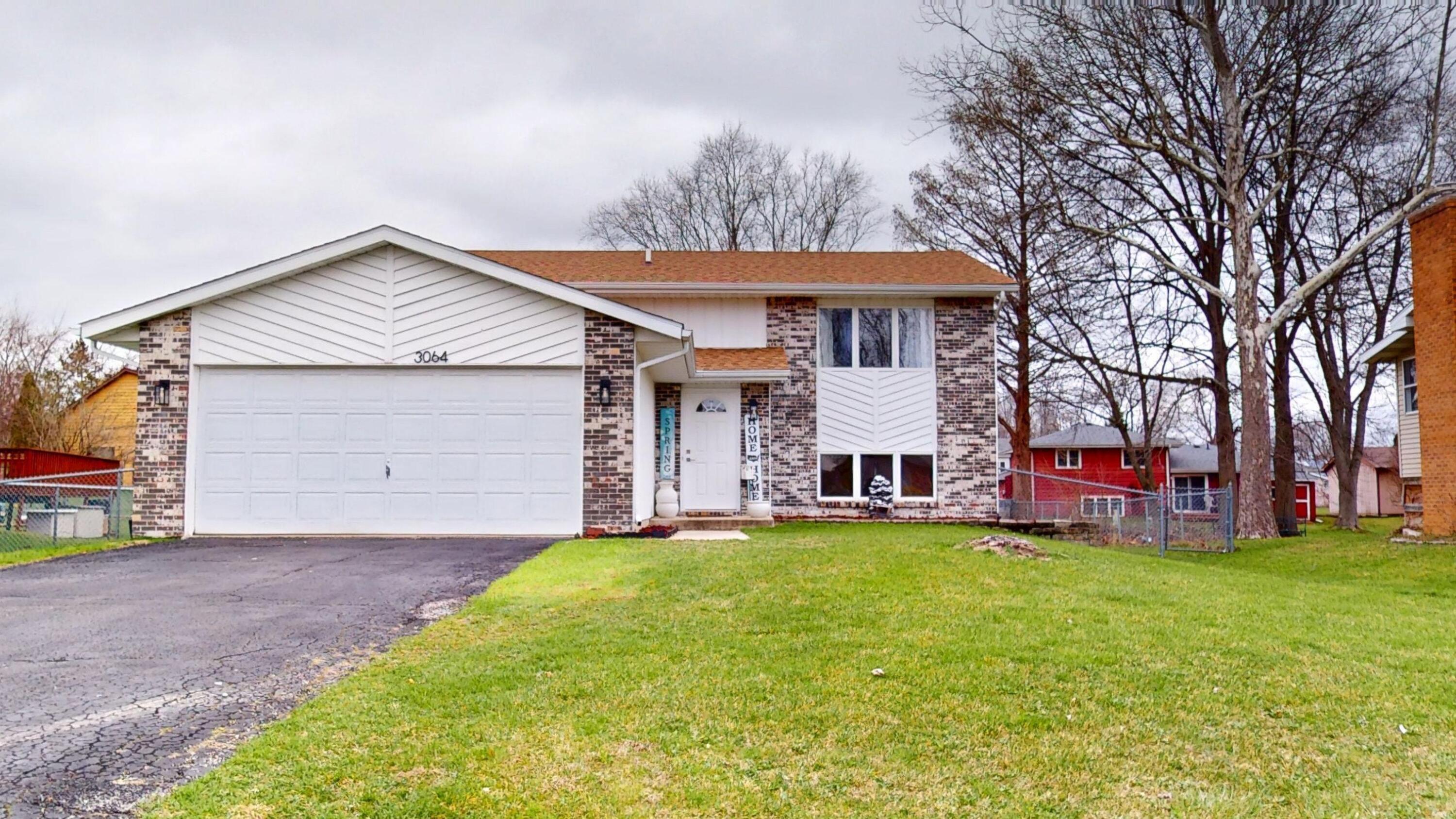 3064 Parkwood Place Crown Point, IN 46307 - Photo 1 of 40 a view of a house with a yard and sitting area
