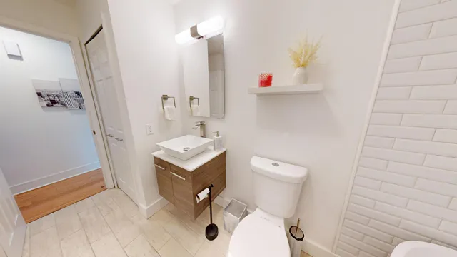 a bathroom with a sink a toilet and shower curtain