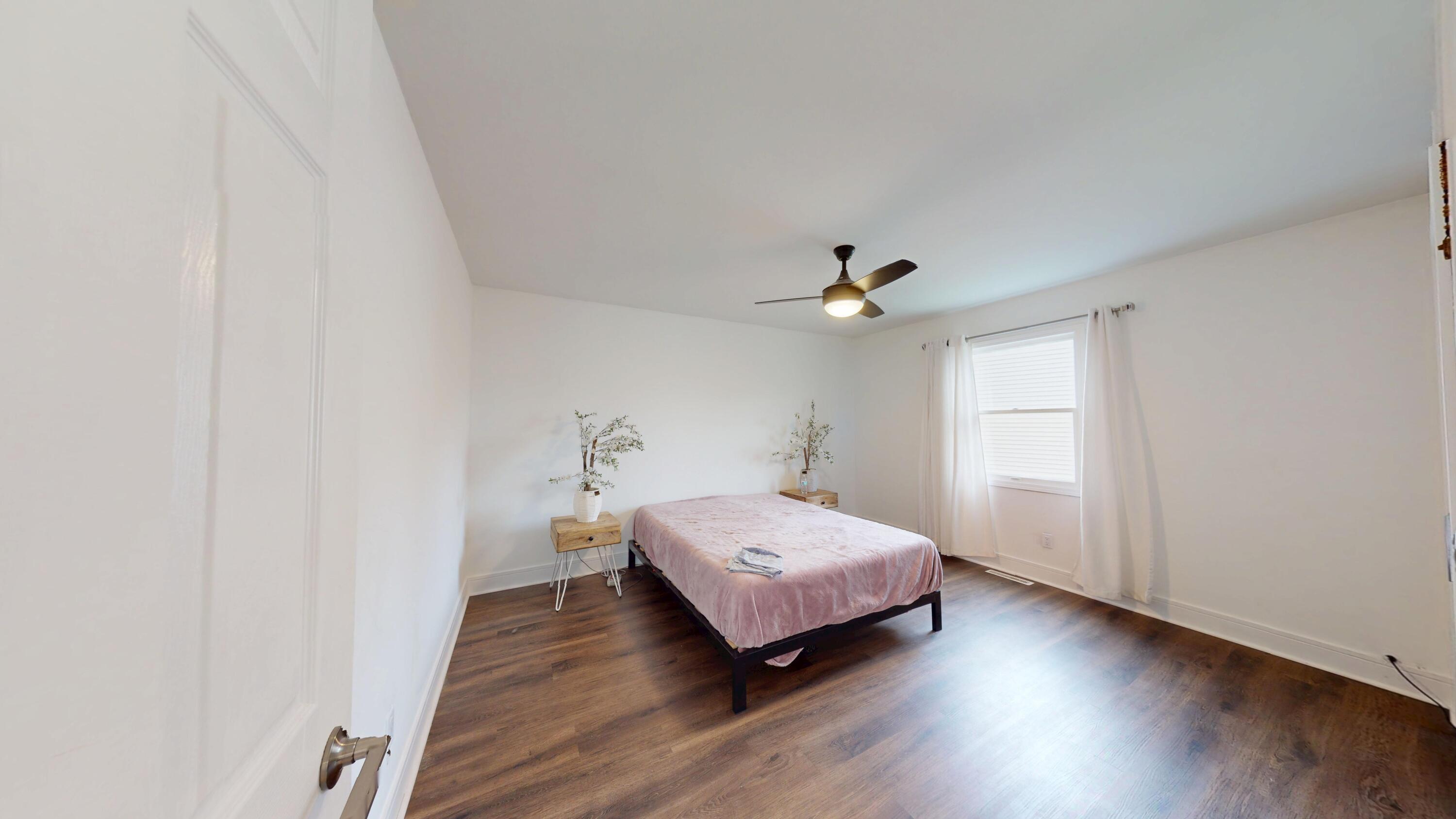 3064 Parkwood Place Crown Point, IN 46307 - Photo 17 of 40 a spacious bedroom with a bed and a ceiling fan