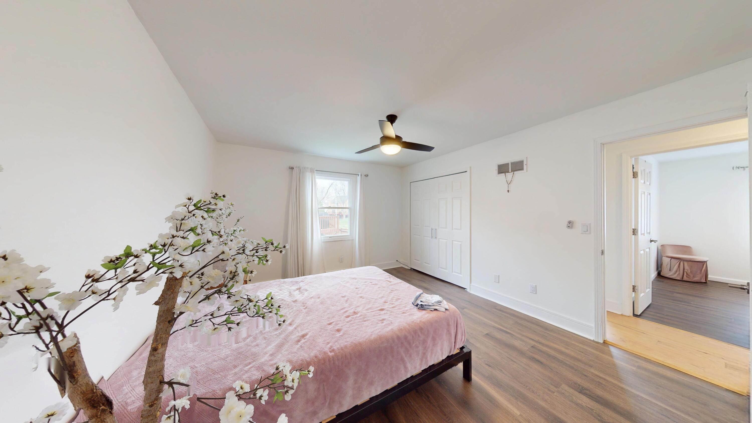 3064 Parkwood Place Crown Point, IN 46307 - Photo 18 of 40 a spacious bedroom with a large bed and a chandelier