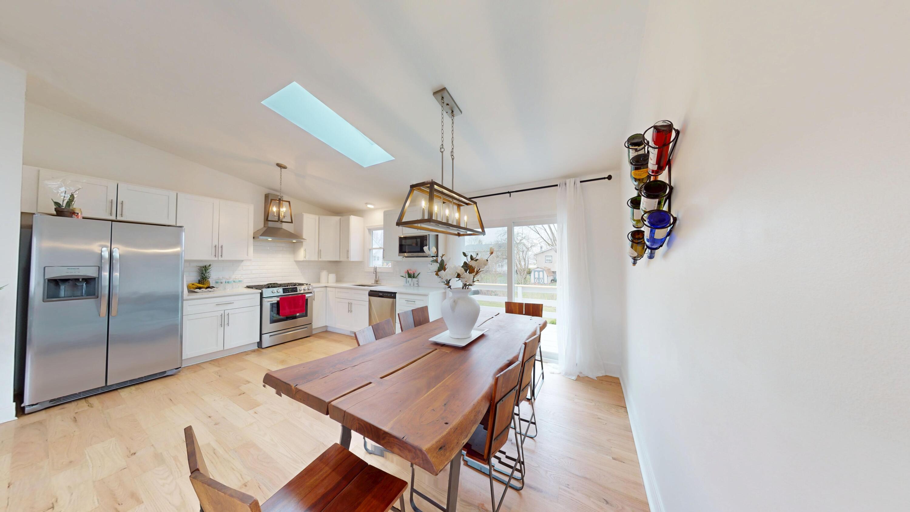 3064 Parkwood Place Crown Point, IN 46307 - Photo 7 of 40 a kitchen with stainless steel appliances granite countertop a sink refrigerator and microwave