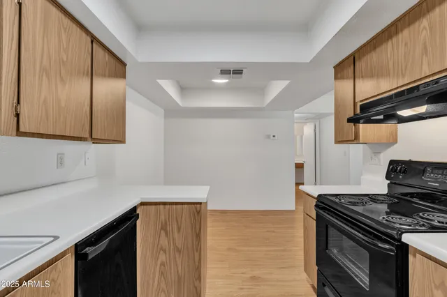 a kitchen with stainless steel appliances granite countertop a stove and a refrigerator