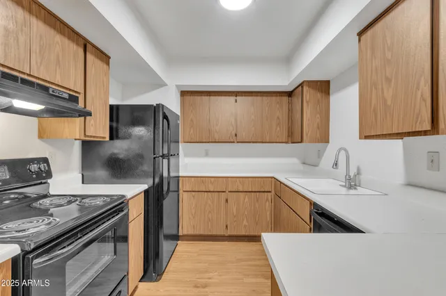 a kitchen with a sink stove and refrigerator