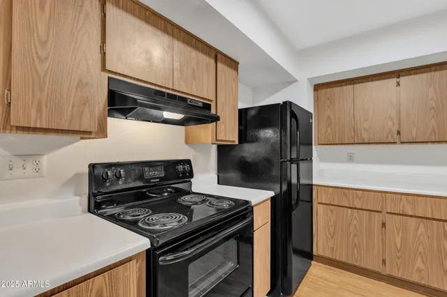 a kitchen with a stove and a refrigerator