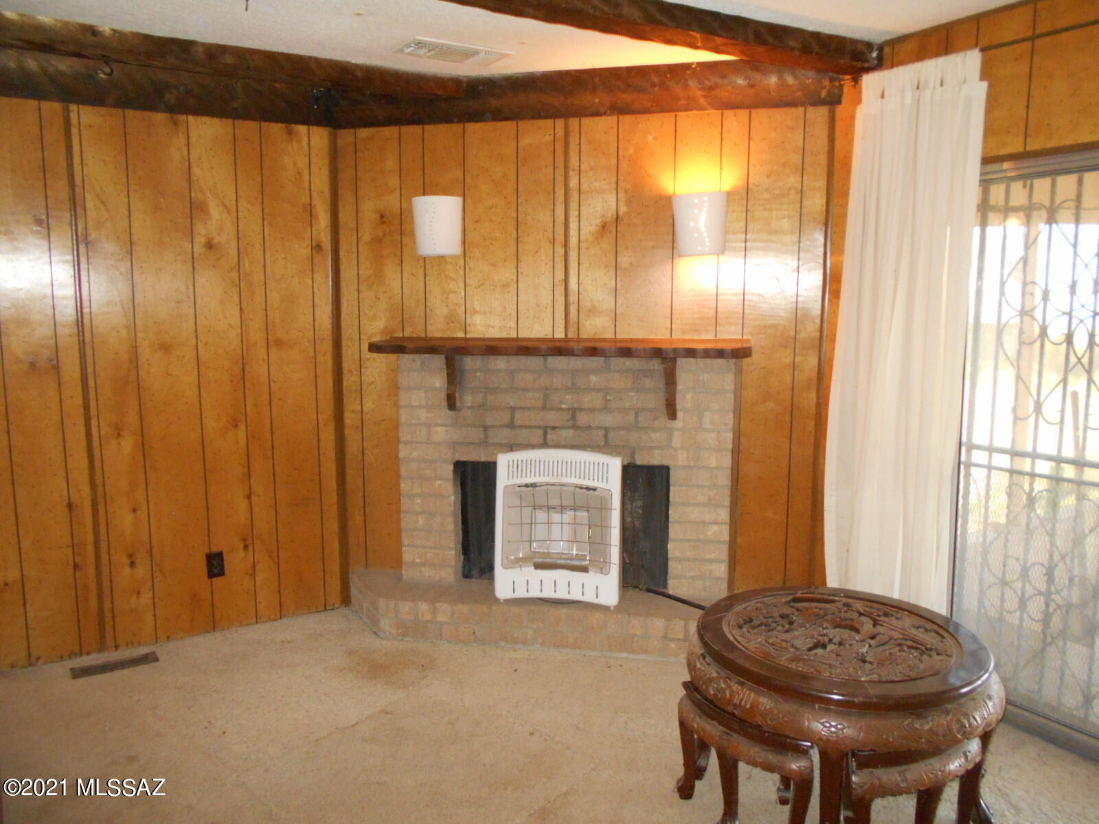 5321 North Rocky Road Douglas, AZ 85607 - Photo 15 of 41 a living room with a fireplace and a window