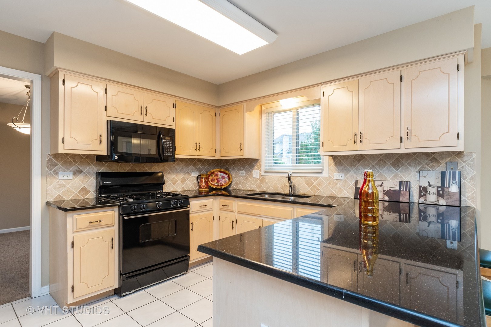 2215 Snow Creek Road Naperville, IL 60564 - Photo 4 of 18 a kitchen with stainless steel appliances granite countertop a stove a sink and a microwave