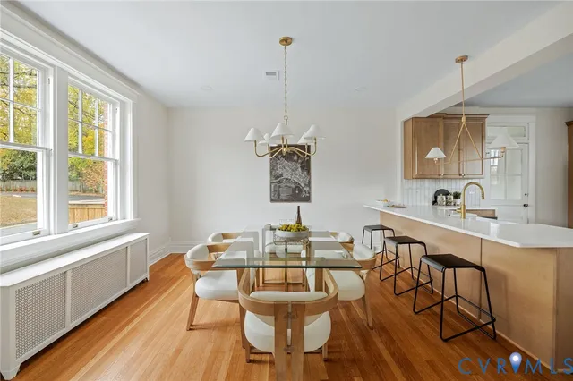 a view of a dining room with furniture window and wooden floor