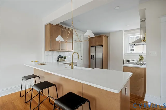 a kitchen with stainless steel appliances a sink and a refrigerator