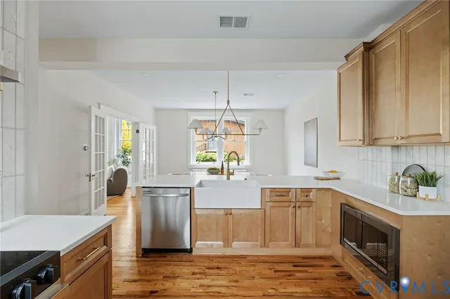 a kitchen with stainless steel appliances a sink stove and cabinets