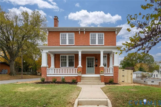 a front view of a house with a yard table and chairs