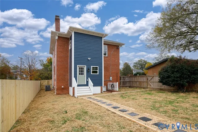 a pathway of a house with a yard