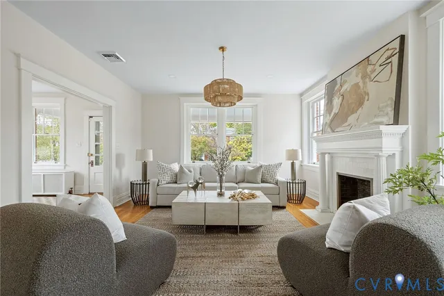 a living room with furniture large window and fireplace