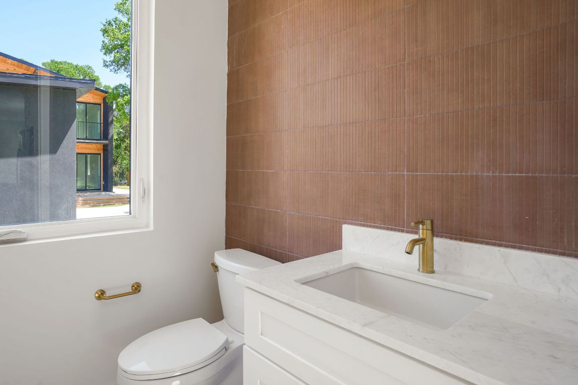 2609 Davis Lane, Unit 2 Austin, TX 78748 - Photo 13 of 23 a white toilet sitting next to a bathroom sink