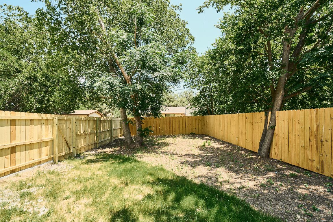 2609 Davis Lane, Unit 2 Austin, TX 78748 - Photo 23 of 23 a view of backyard with wooden fence and large trees