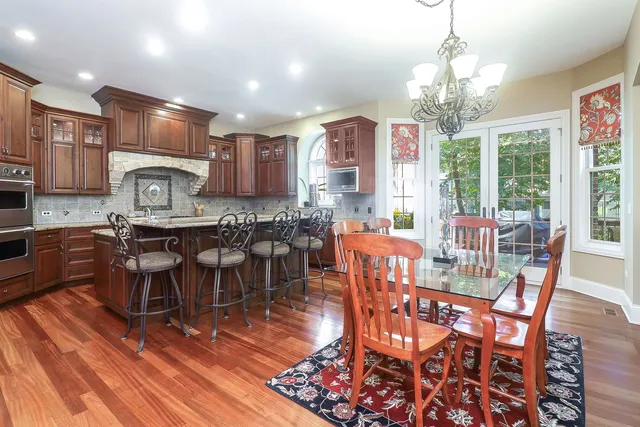 a view of a dining room with furniture a chandelier and wooden floor