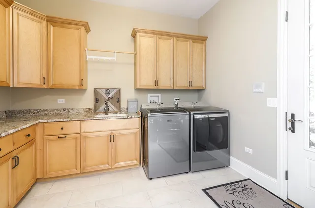 a living room with furniture a lamp wooden floor and a table