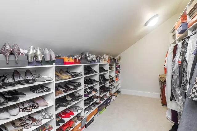 a view of walk in closet with clothes