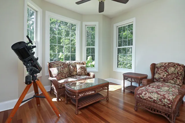 a dining room with furniture potted plants and wooden floor