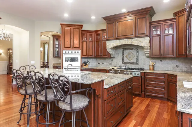 a kitchen with stainless steel appliances granite countertop wooden cabinets a sink and a stove