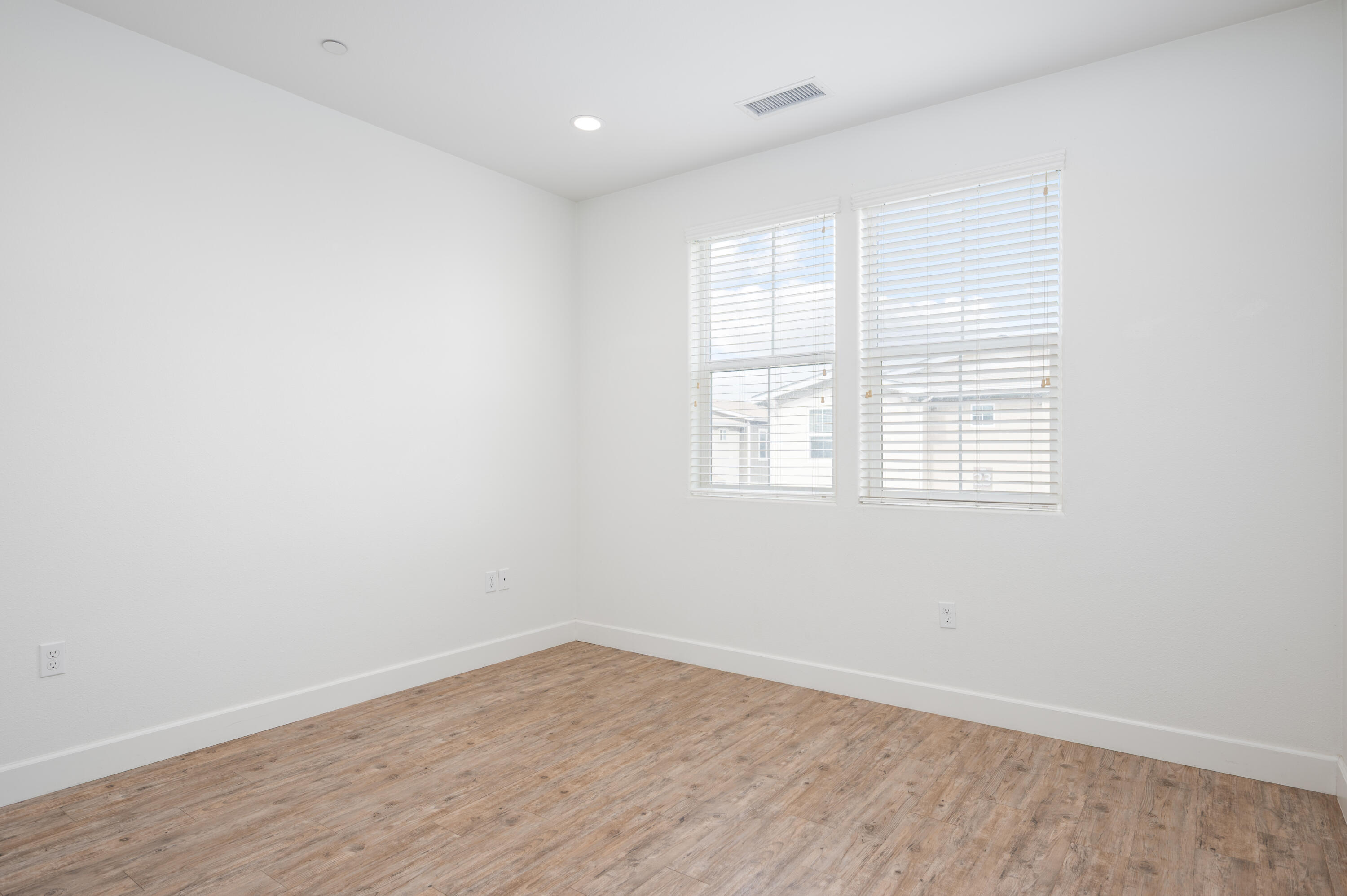 246 Robles Way Buellton, CA 93427 - Photo 16 of 26 an empty room with wooden floor and windows