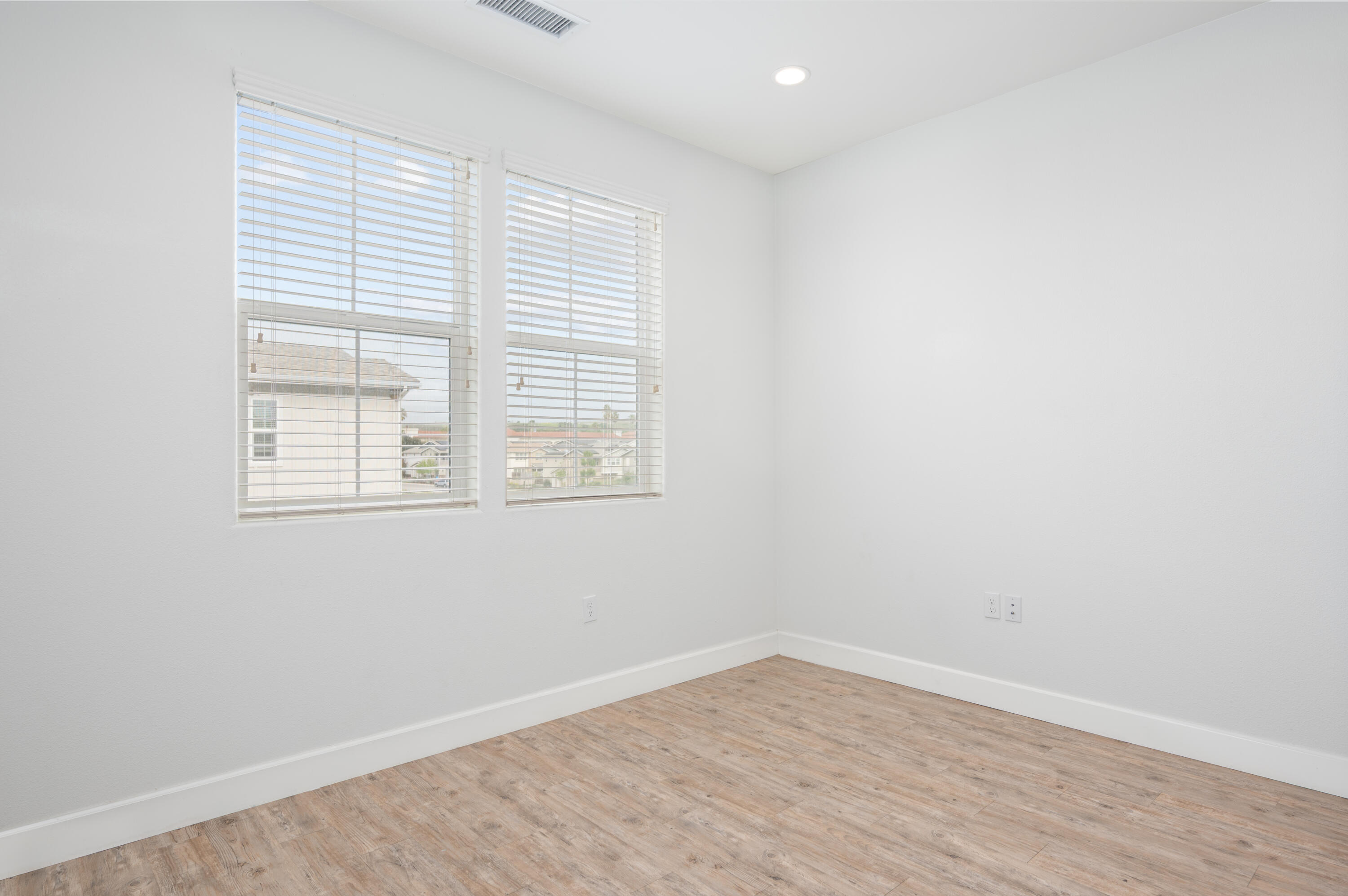 246 Robles Way Buellton, CA 93427 - Photo 20 of 26 an empty room with wooden floor and windows