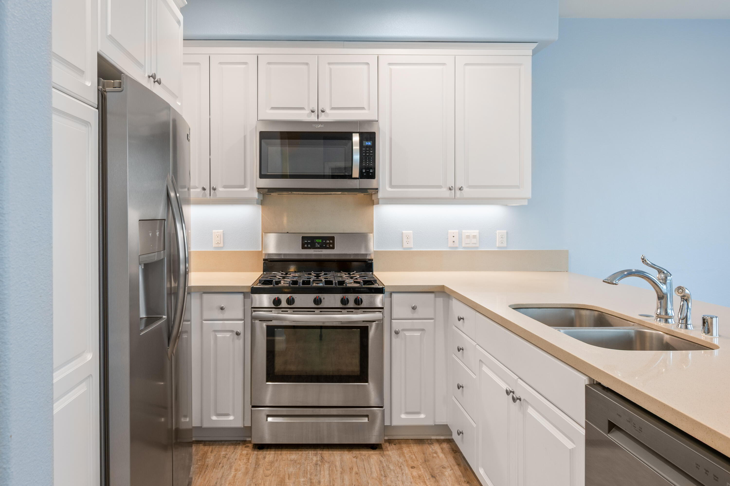 246 Robles Way Buellton, CA 93427 - Photo 7 of 26 a kitchen with white cabinets and stainless steel appliances