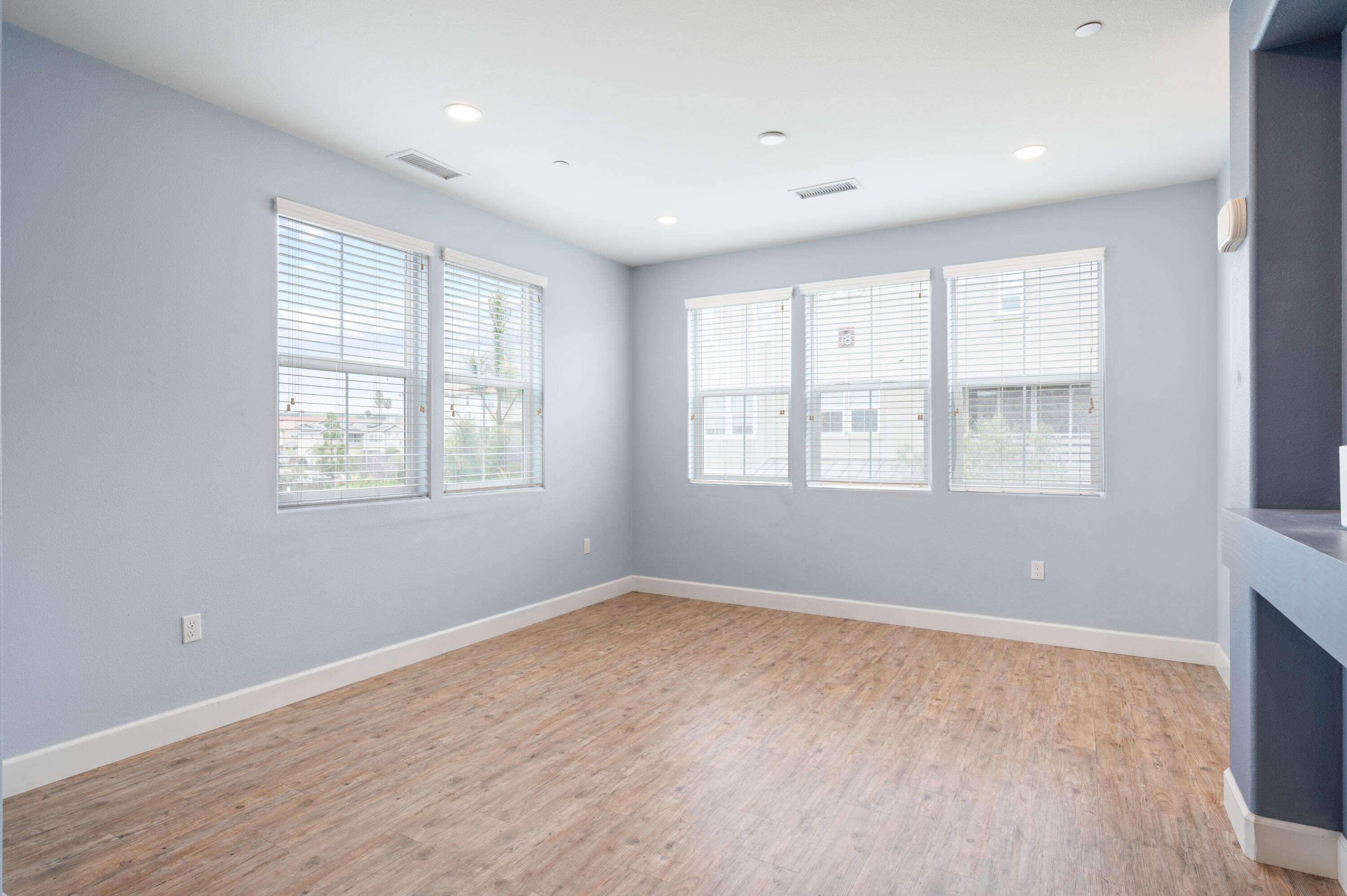 246 Robles Way Buellton, CA 93427 - Photo 10 of 26 a view of an empty room with wooden floor and a window