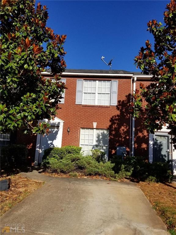 5760 Strathmoor Manor Circle Lithonia, GA 30058 - Photo 1 of 1 a front view of a house with a yard