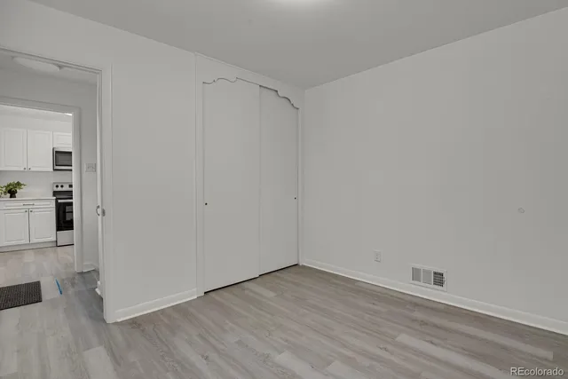 a view of a room with wooden floor