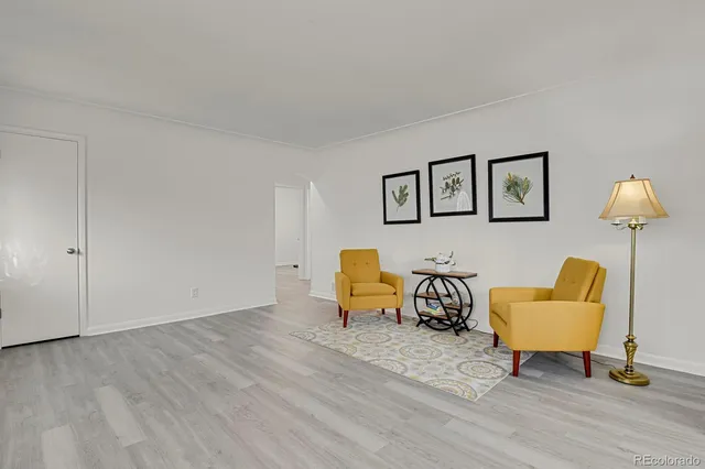 a view of a livingroom with chairs and couch