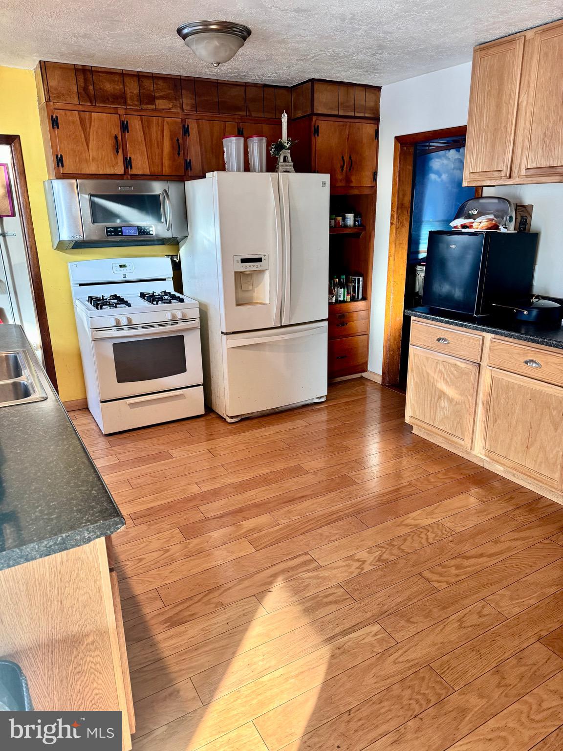 1286 Harding Road Vineland, NJ 08361 - Photo 6 of 40 a kitchen with stainless steel appliances a stove a microwave and a refrigerator