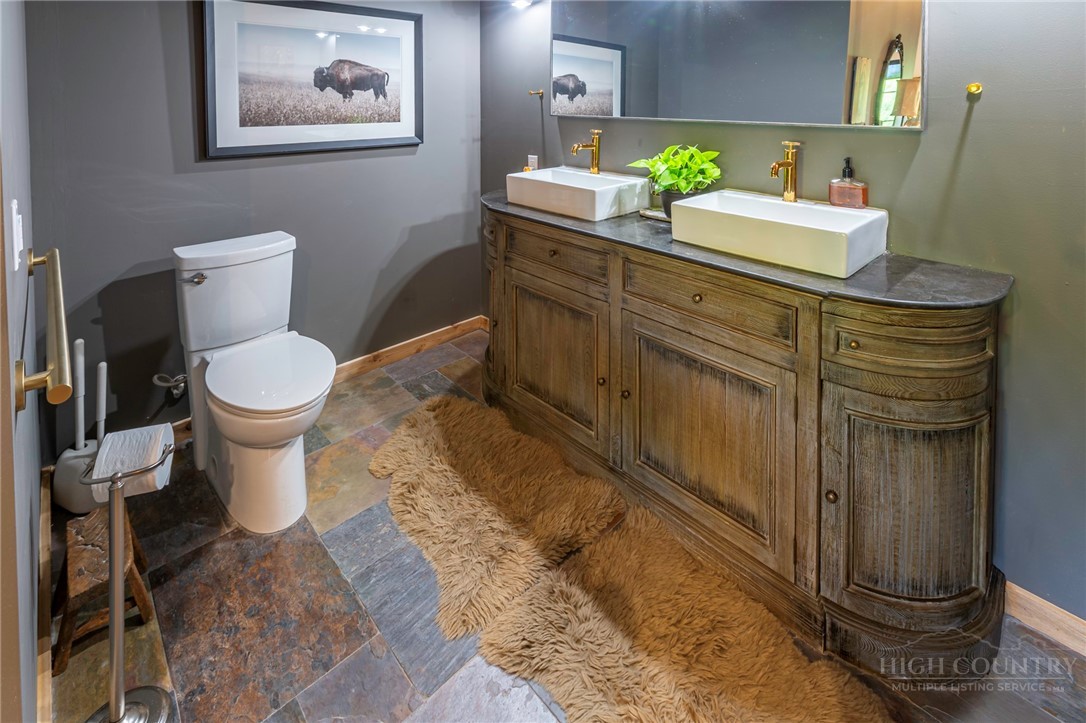 509 Grant Houck Road Todd, NC 28684 - Photo 31 of 43 a bathroom with a toilet sink and mirror