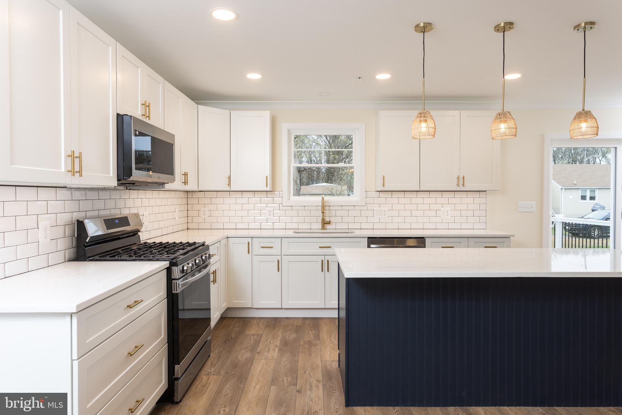 2905 Sparrows Point Road Sparrows Point, MD 21219 - Photo 11 of 32 a kitchen with a sink stove and cabinets