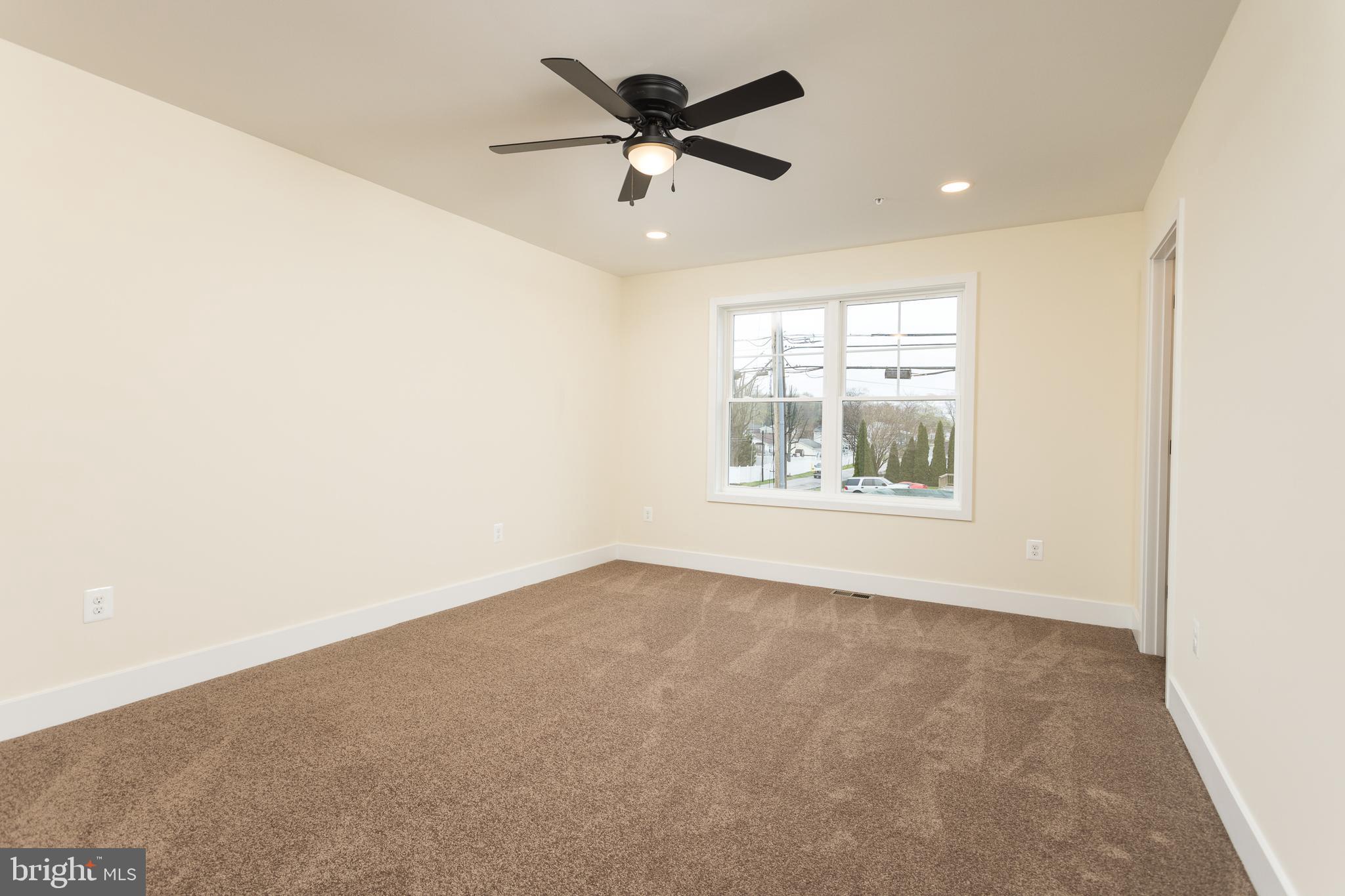 2905 Sparrows Point Road Sparrows Point, MD 21219 - Photo 22 of 32 an empty room with windows and ceiling fan