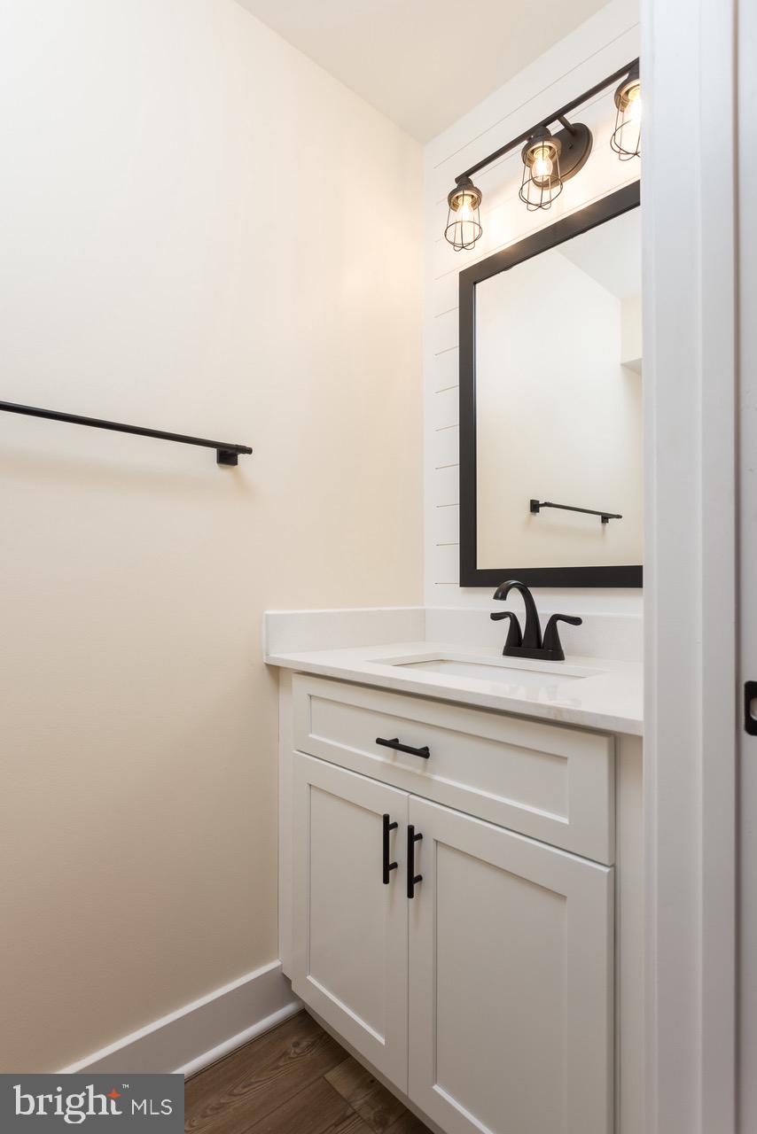 2905 Sparrows Point Road Sparrows Point, MD 21219 - Photo 7 of 32 a bathroom with a sink a vanity and a mirror