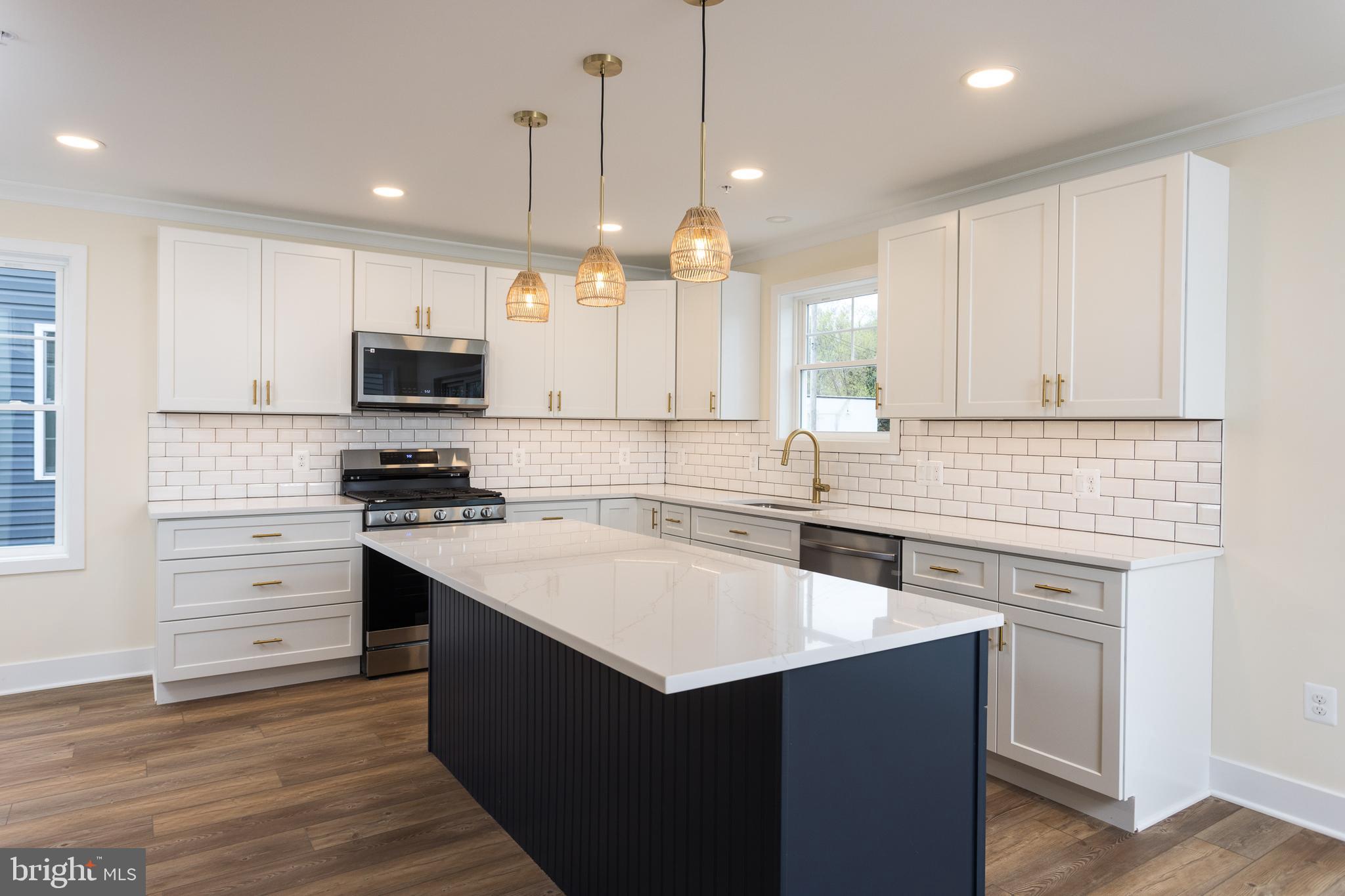 2905 Sparrows Point Road Sparrows Point, MD 21219 - Photo 10 of 32 a kitchen with kitchen island a sink stainless steel appliances and cabinets