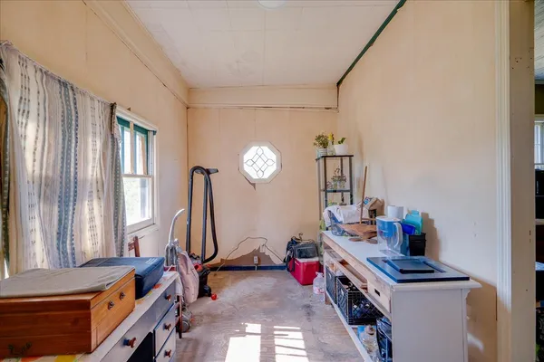 a view of a hallway with furniture and windows