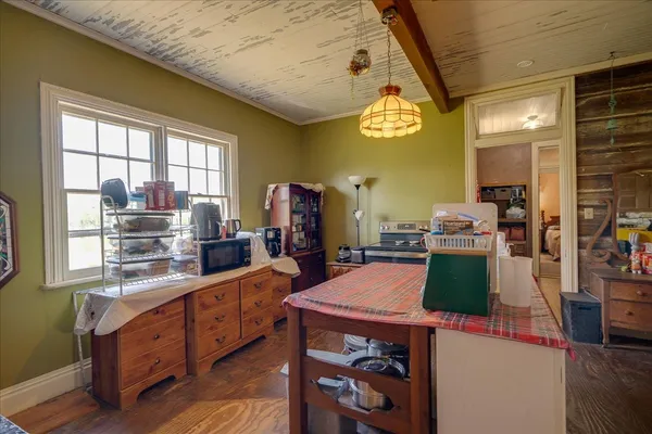 a large kitchen with a large window and stainless steel appliances