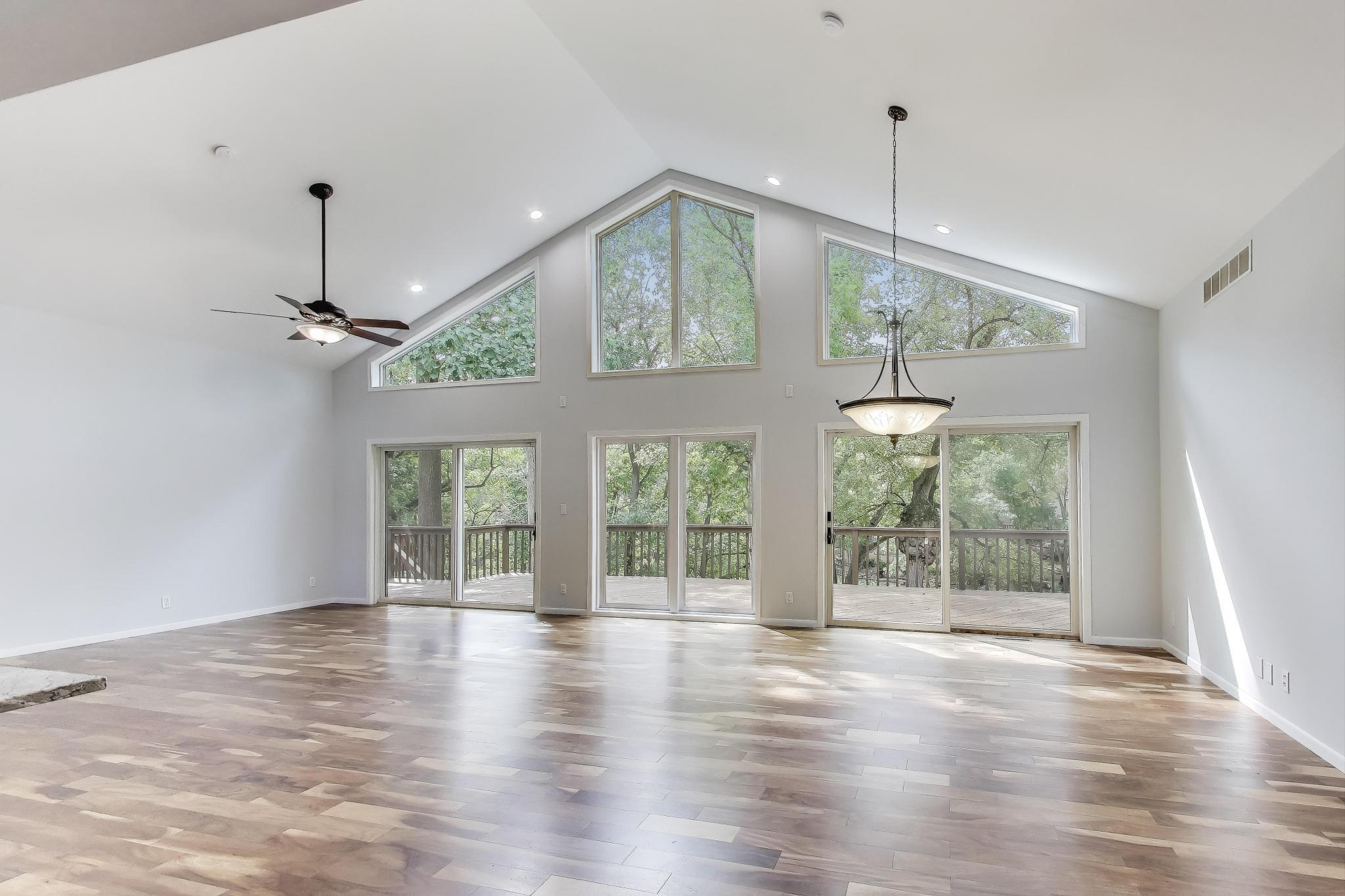 1009 Lake George Drive Hobart, IN 46342 - Photo 11 of 73 an empty room with wooden floor chandelier and outdoor space