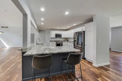 a bedroom with a bed and large windows