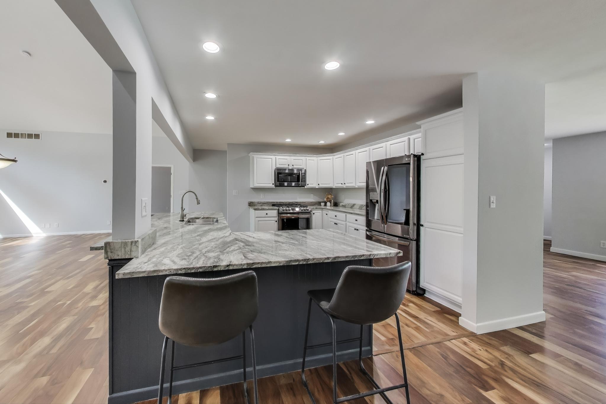 1009 Lake George Drive Hobart, IN 46342 - Photo 17 of 73 a kitchen with stainless steel appliances granite countertop a table chairs sink and cabinets