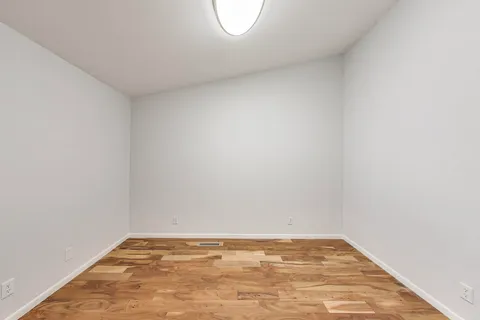 a spacious bathroom with a granite countertop sink a mirror and a vanity