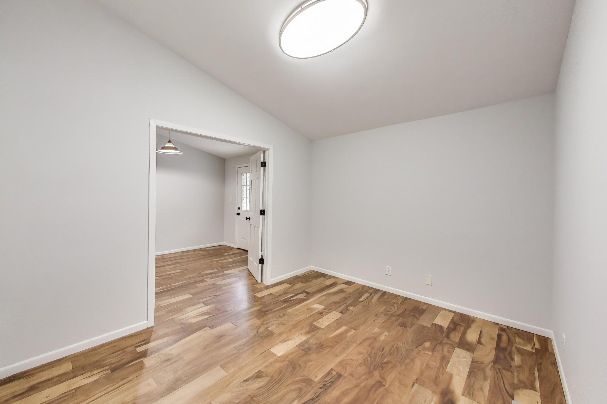 1009 Lake George Drive Hobart, IN 46342 - Photo 21 of 73 an empty room with wooden floor and mirror