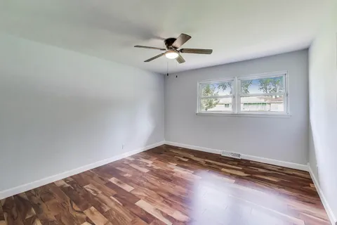 a view of an empty room with stairs and a furniture